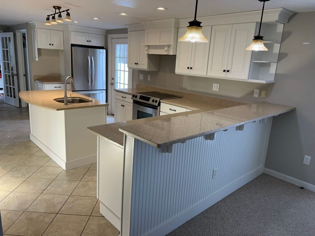 Freshly remodeled kitchen cabinets painted in a bright white finish.