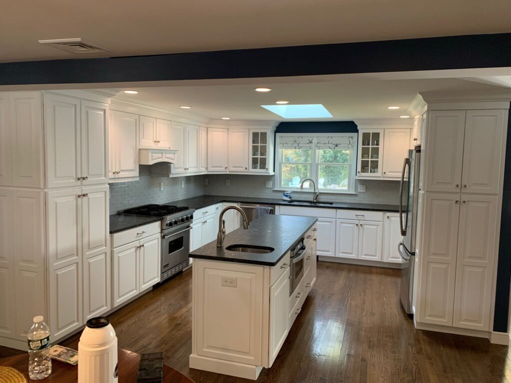 Freshly remodeled kitchen cabinets painted in a bright white finish.