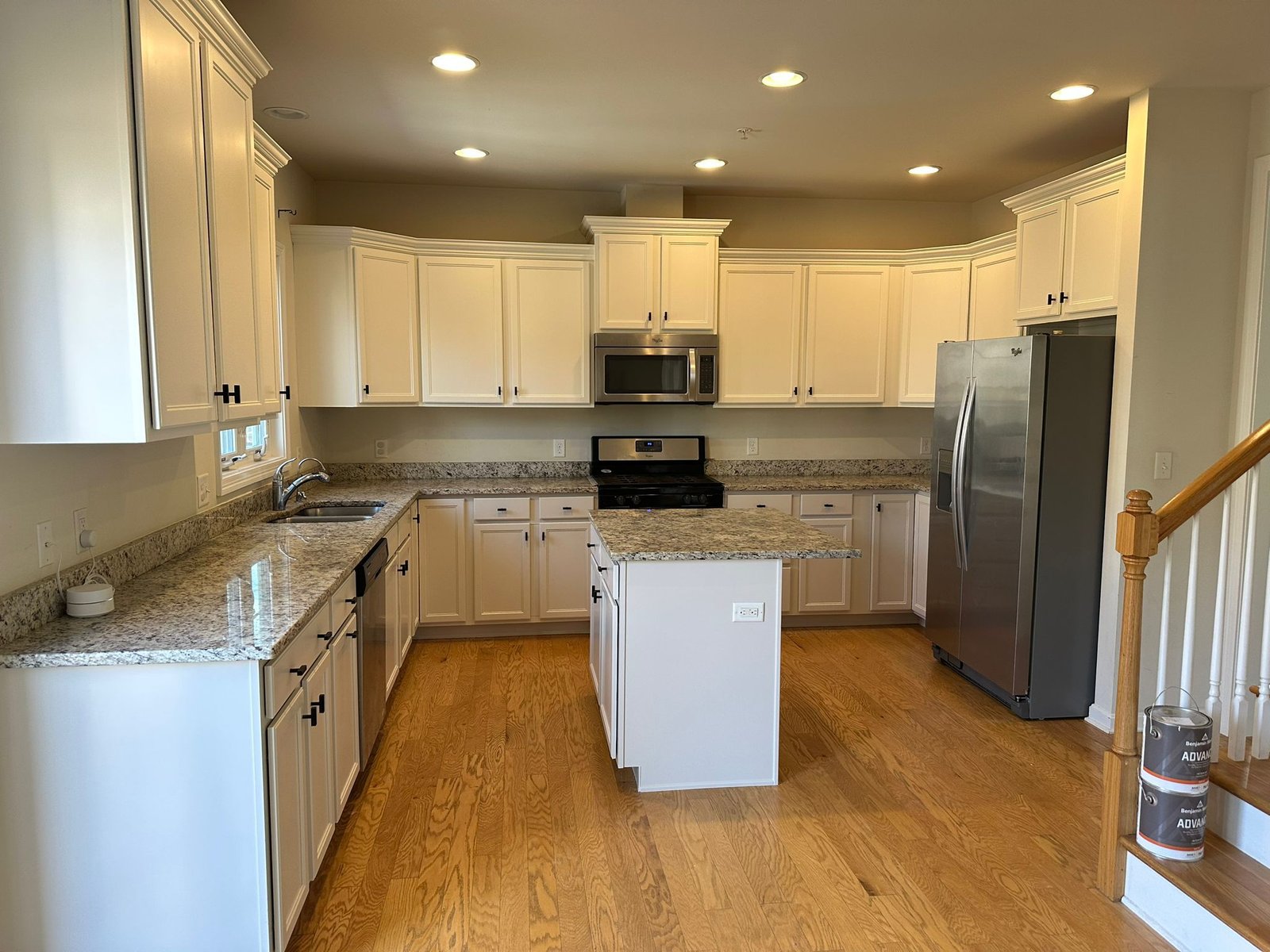 Freshly remodeled kitchen cabinets painted in a bright white finish.