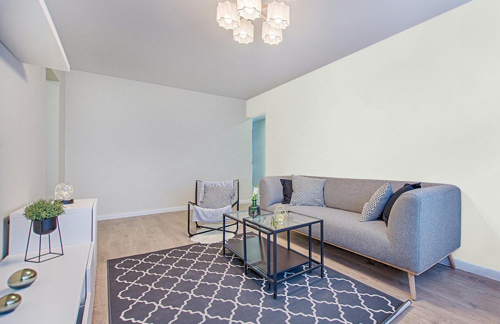 Living room showcasing a specific paint color on the wall. Color: Pure white by Sherwin-Williams